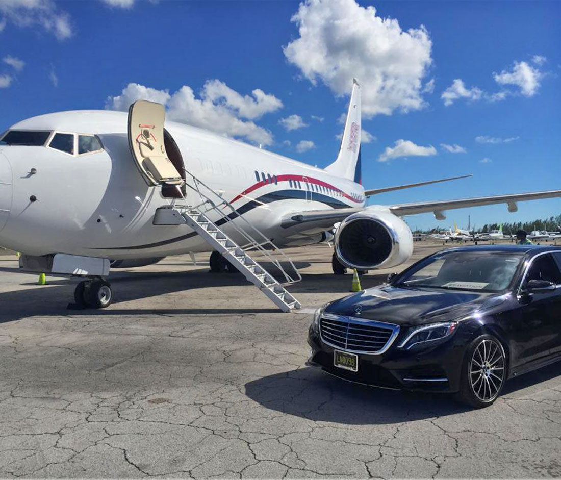 black car infront of an small jet